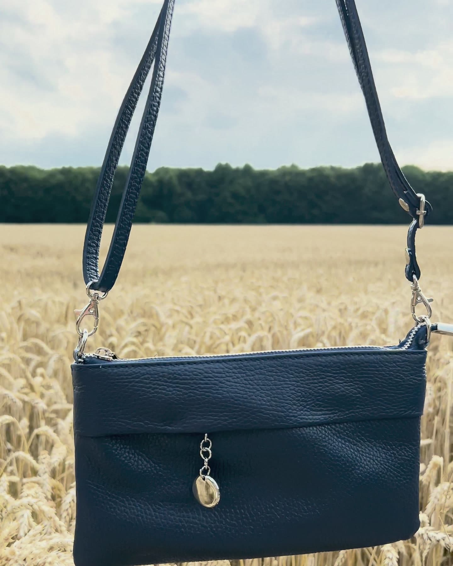 Vienna Mini Henkeltasche am langen Riemen über einem Weizenfeld